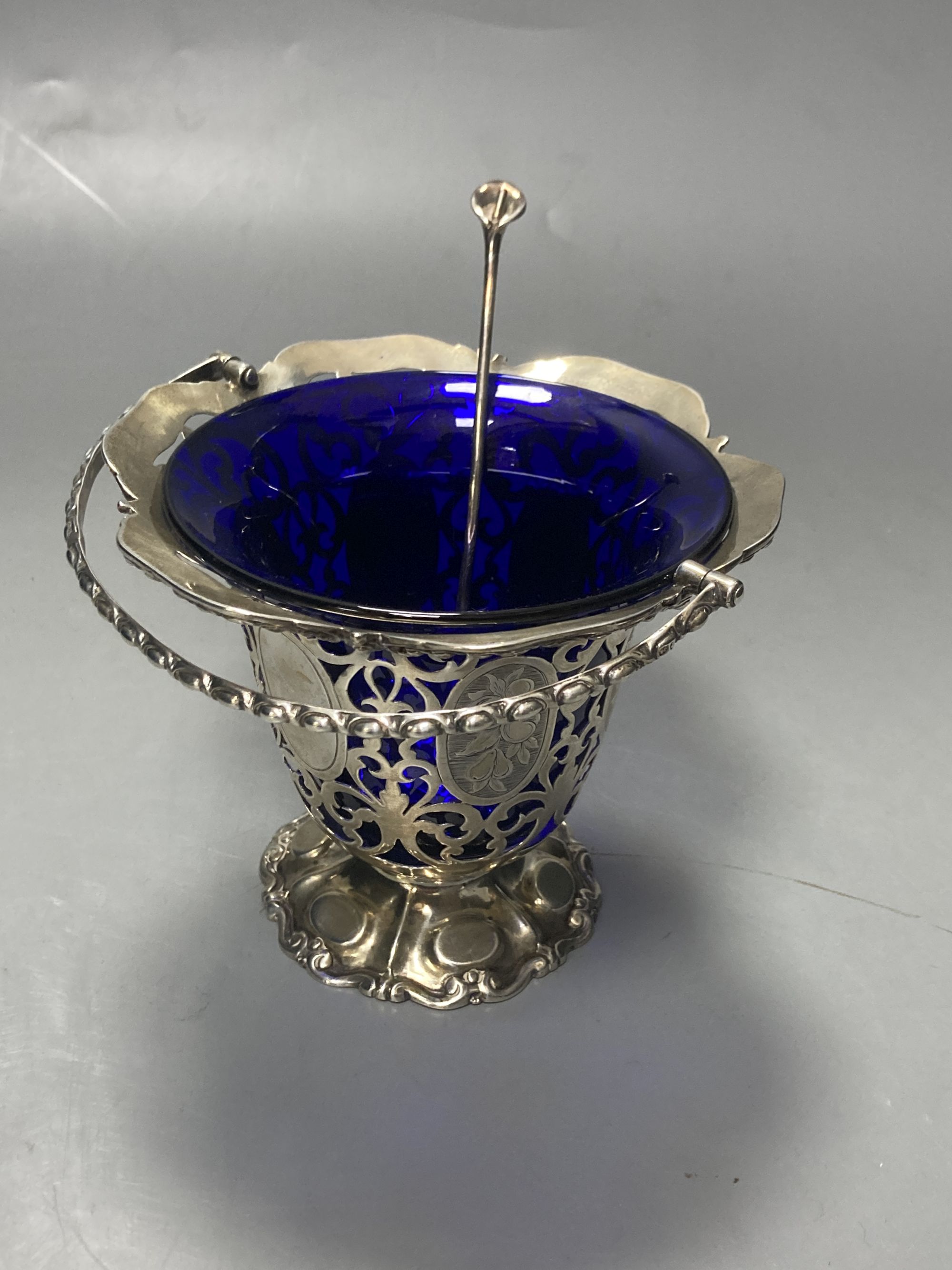 A Victorian pierced silver sugar basket, with blue glass liner and later engraved inscription, George Angell, London, 1854,